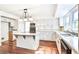 Well-lit kitchen with white cabinets, granite counters, and an island with a cooktop at 1541 Diamond Blvd, Mount Pleasant, SC 29466