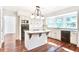 Bright kitchen featuring white cabinets, granite countertops, and an island with decorative supports at 1541 Diamond Blvd, Mount Pleasant, SC 29466