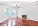 Bright living room featuring a fireplace, bay windows, and hardwood floors at 1541 Diamond Blvd, Mount Pleasant, SC 29466