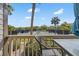 Balcony seating area overlooking community tennis courts and landscaped greenery on a sunny day at 1619 Live Oak Park, Johns Island, SC 29455
