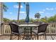 Outdoor deck with a patio table, umbrella, and comfortable seating overlooking a scenic view at 1619 Live Oak Park, Johns Island, SC 29455
