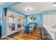Charming dining area with a blue table and chairs, complemented by rustic decor and natural light at 1619 Live Oak Park, Johns Island, SC 29455