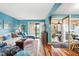 Bright living room boasts blue walls, wood floors, and sliding door access to the outdoor porch at 1619 Live Oak Park, Johns Island, SC 29455