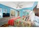 Bright main bedroom boasts colorful bedding, hardwood floors, and a sliding door access to the outdoor porch at 1619 Live Oak Park, Johns Island, SC 29455