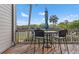 Charming patio seating area offering views of the tennis courts and palm trees at 1619 Live Oak Park, Johns Island, SC 29455
