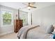 Cozy bedroom with four-poster bed, wooden dresser, and natural light from two windows at 1644 Fort Palmetto Cir, Mount Pleasant, SC 29466