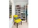 Organized closet featuring built-in shelving, a yellow chair, and stylish decor at 1644 Fort Palmetto Cir, Mount Pleasant, SC 29466