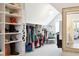 Spacious walk-in closet with custom shelving, hanging racks, and a chandelier at 1644 Fort Palmetto Cir, Mount Pleasant, SC 29466