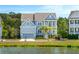 Charming two-story home with a well-manicured lawn and water view at 1644 Fort Palmetto Cir, Mount Pleasant, SC 29466