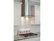 Close-up of a modern range hood with a tiled backsplash over a gas range and the words 'Beach House' at 1644 Fort Palmetto Cir, Mount Pleasant, SC 29466