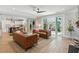 Open-concept living space with leather couches, a ceiling fan, and seamless access to a covered outdoor patio at 1644 Fort Palmetto Cir, Mount Pleasant, SC 29466