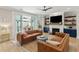 Comfortable living room boasts a fireplace, media center, leather couches, and a sliding glass door to the patio at 1644 Fort Palmetto Cir, Mount Pleasant, SC 29466