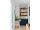 Cozy living area featuring custom shelves, a white brick wall, and blue cabinets for style at 1644 Fort Palmetto Cir, Mount Pleasant, SC 29466