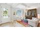 Bright living room featuring stylish furnishings, unique lighting, wood floors, and serene pond view at 1644 Fort Palmetto Cir, Mount Pleasant, SC 29466