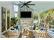Cozy screened-in patio with a fireplace, plush seating, and a view of the pool at 1644 Fort Palmetto Cir, Mount Pleasant, SC 29466