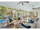 Spacious screened-in patio with ample seating and a view of the pool and outdoor dining area at 1644 Fort Palmetto Cir, Mount Pleasant, SC 29466