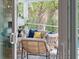 Relaxing screened-in patio with comfortable seating overlooking lush greenery and a swimming pool at 1644 Fort Palmetto Cir, Mount Pleasant, SC 29466
