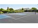 Brightly colored tennis court with benches, net, and tall fencing in a community setting at 1644 Fort Palmetto Cir, Mount Pleasant, SC 29466