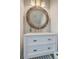 Charming bathroom with a round wooden mirror, marble countertop vanity, and stylish fixtures, creating a spa-like retreat at 169 Jackson St, Charleston, SC 29403