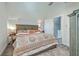 Comfortable bedroom with wood accent headboard, ceiling fan, and decoratively patterned bedspread at 169 Jackson St, Charleston, SC 29403