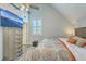 Bright bedroom featuring television, ceiling fan, a window with plantation shutters and decorative pillows at 169 Jackson St, Charleston, SC 29403