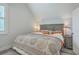 Bright bedroom with a window and wood accent headboard, ceiling fan, and decorative patterned bedspread at 169 Jackson St, Charleston, SC 29403