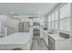 Modern kitchen with stainless steel appliances, quartz counters and a small table at 169 Jackson St, Charleston, SC 29403