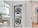 Convenient laundry area featuring a stacked washer and dryer unit, adjacent to a bedroom for easy access at 169 Jackson St, Charleston, SC 29403