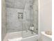 Luxurious walk-in shower features elegant tile work, a built-in niche, and a sleek glass door for a spa-like experience at 169 Jackson St, Charleston, SC 29403