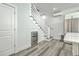 Staircase with modern white railings, a built-in wine fridge, and sleek wood-look flooring for a stylish and functional design at 169 Jackson St, Charleston, SC 29403
