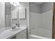 Bright bathroom featuring a tub and shower combination, a vanity with sink, and a mirrored cabinet at 1735 Telfair Way, Charleston, SC 29412