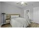 This bedroom features hardwood floors, a queen bed, a ceiling fan, and a view into the attached bathroom at 1735 Telfair Way, Charleston, SC 29412