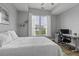Bright bedroom with a large window, comfortable bed, and a modern desk, perfect for relaxation and work at 1735 Telfair Way, Charleston, SC 29412