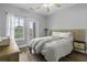 Cozy bedroom with hardwood floors, a queen bed, a ceiling fan, and access to a balcony with natural light at 1735 Telfair Way, Charleston, SC 29412