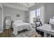 Inviting bedroom with natural light, a cozy bed, modern accents, and a convenient workspace for relaxation and productivity at 1735 Telfair Way, Charleston, SC 29412
