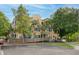 Exterior view of a bright yellow apartment building featuring a ramp and ample parking spaces for easy accessibility at 1735 Telfair Way, Charleston, SC 29412