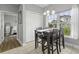 Charming dining area with view to bedroom, featuring a dark wood table, four chairs, and natural light at 1735 Telfair Way, Charleston, SC 29412