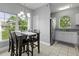 Bright dining area with a large window, modern chandelier, and a cozy table perfect for Gathering meals at 1735 Telfair Way, Charleston, SC 29412