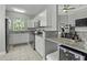 Bright, modern kitchen features granite countertops, stainless steel appliances, and a cozy ambiance for cooking and entertaining at 1735 Telfair Way, Charleston, SC 29412
