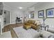 Open concept living room with work space and light brown leather sofa at 1735 Telfair Way, Charleston, SC 29412