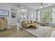 Bright living room featuring a ceiling fan, multiple windows, and an open concept at 1735 Telfair Way, Charleston, SC 29412