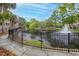 Scenic view of a tranquil pond with a fountain, surrounded by lush greenery and walkways, adding to the community's charm at 1735 Telfair Way, Charleston, SC 29412