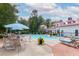 Community swimming pool with lounge chairs and umbrellas surrounded by mature trees on a sunny day at 1735 Telfair Way, Charleston, SC 29412