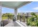Open-air balcony with comfortable wicker furniture and a view of surrounding community at 200 River Landing Dr # D310, Charleston, SC 29492