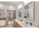 Spa-like bathroom featuring double vanity, decorative mirrors, and glass-enclosed shower at 200 River Landing Dr # D310, Charleston, SC 29492