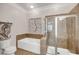 Clean bathroom with soaking tub, glass shower, and neutral tile accents at 200 River Landing Dr # D310, Charleston, SC 29492