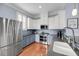 Contemporary kitchen boasts stainless steel appliances, two-toned cabinetry, and hardwood flooring at 200 River Landing Dr # D310, Charleston, SC 29492
