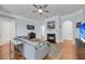 Inviting living room features a fireplace, comfortable sofa, hardwood flooring, and soft blue walls at 200 River Landing Dr # D310, Charleston, SC 29492