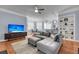 Comfortable living room features a large sofa, TV, hardwood floors, and open access to dining at 200 River Landing Dr # D310, Charleston, SC 29492
