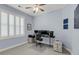 Bright office with a ceiling fan, window with white shutters and a modern workstation at 200 River Landing Dr # D310, Charleston, SC 29492
